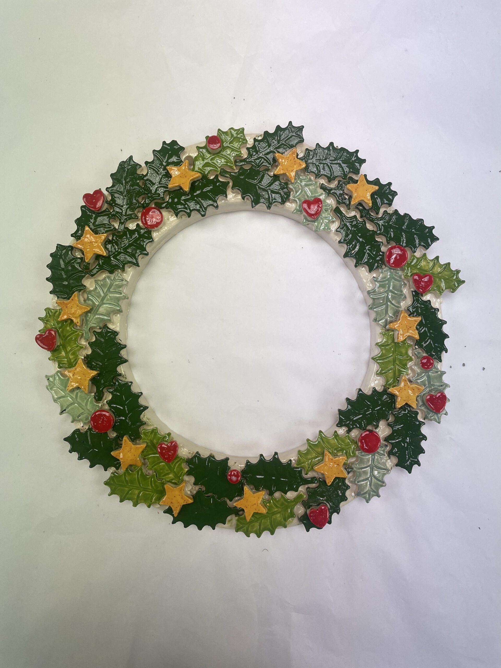 pottery Christmas wreath with holly and stars
